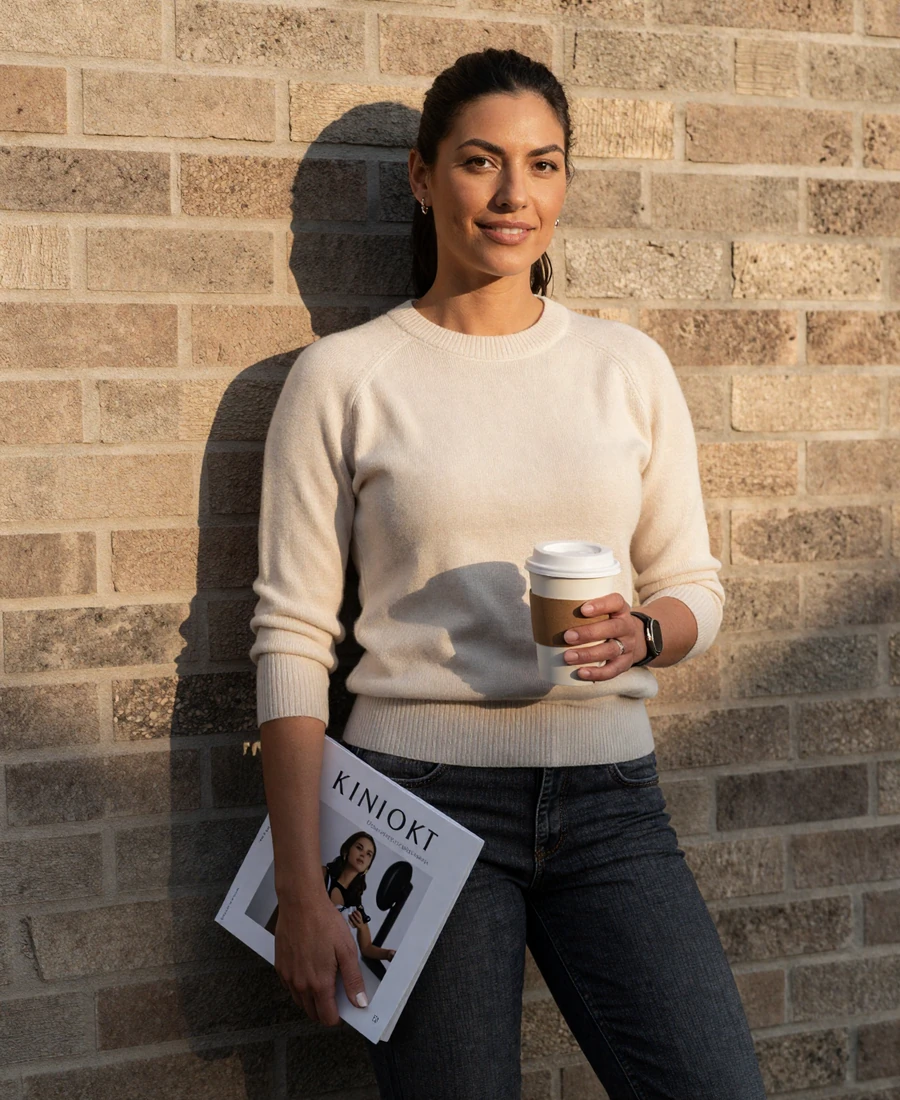 Single woman surgeon outside hospital in lifestyle clothes, featured on the surgeon dating site